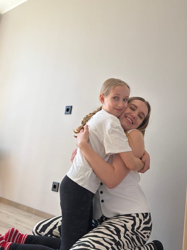 Woman and child share indoor moments in Dreiliņi, Latvia