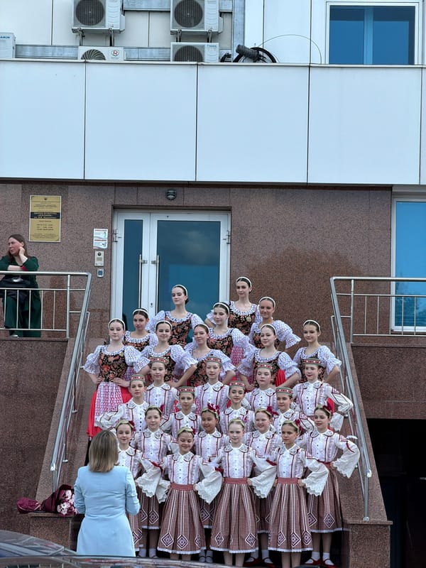 Women in folk costumes pose for photos in Tyumen