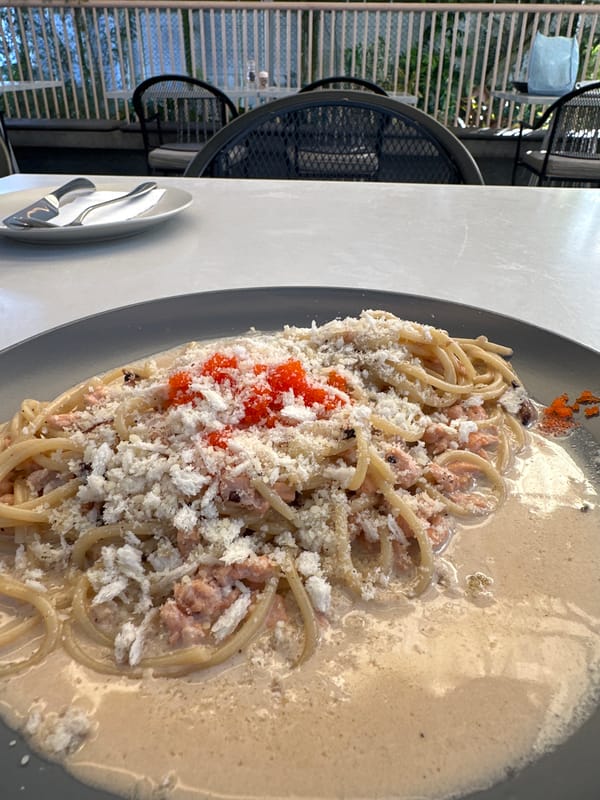 Morning motorcycle ride through tropical city with pasta stop