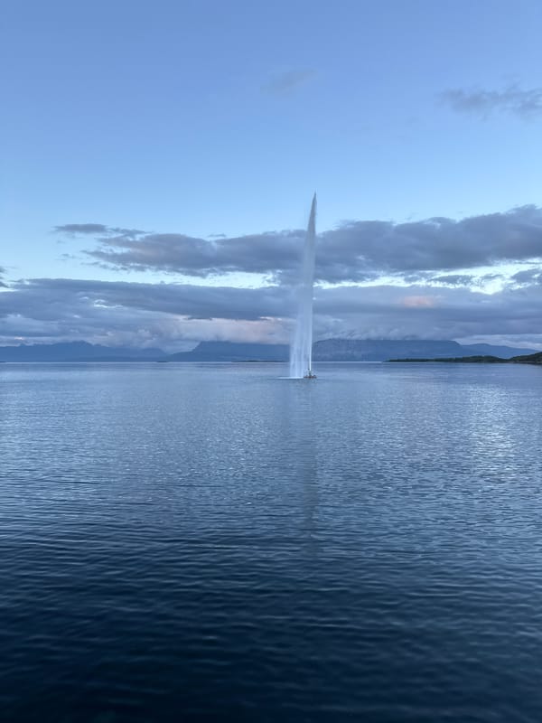 Harstad waterfront at twilight: fjord fountain and modern residential district
