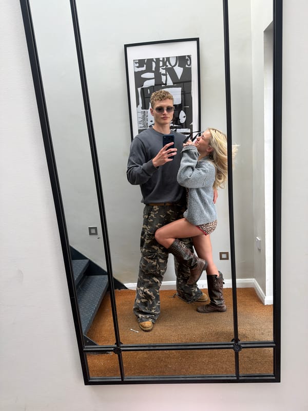 Couple caught in mirror reflection moment in London