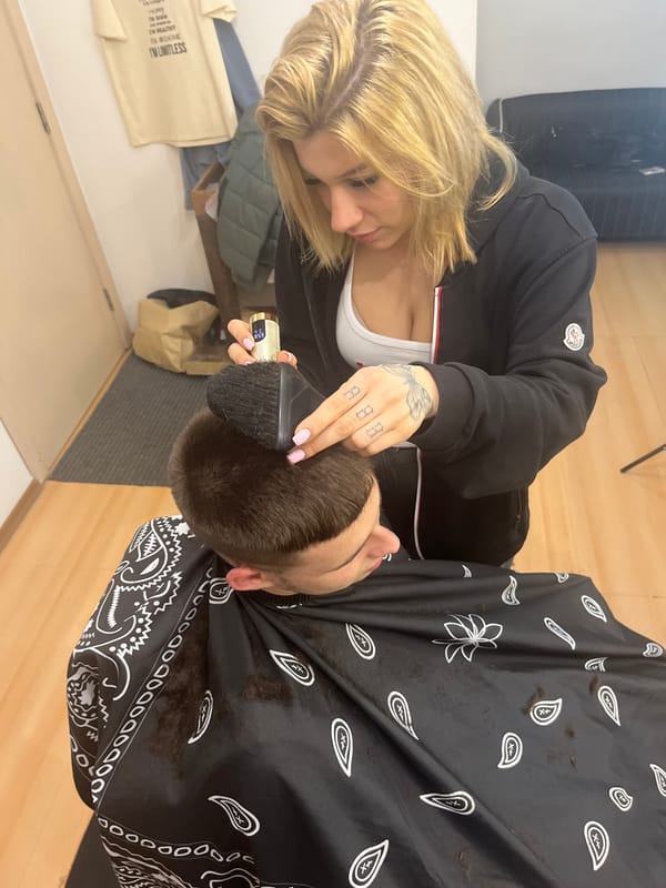 Woman gives haircut to man in Bulgarian salon