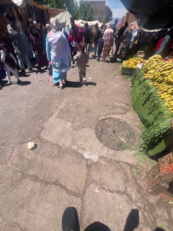 Street market bustles with vendors and shoppers in Ouaouizert