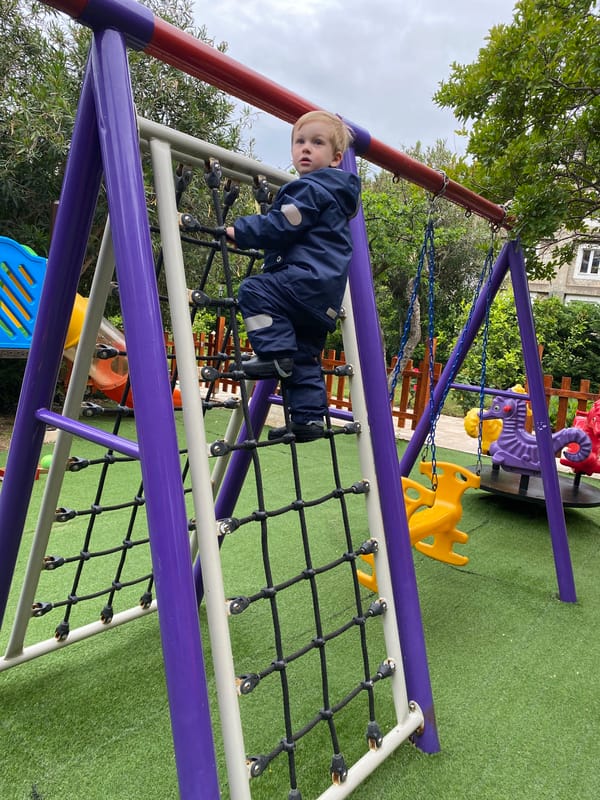Toddler enjoys playground activities in Rafailovići, Montenegro
