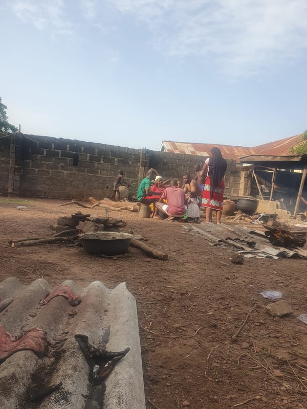 Community gathering observed near brick structure in Idah, Nigeria
