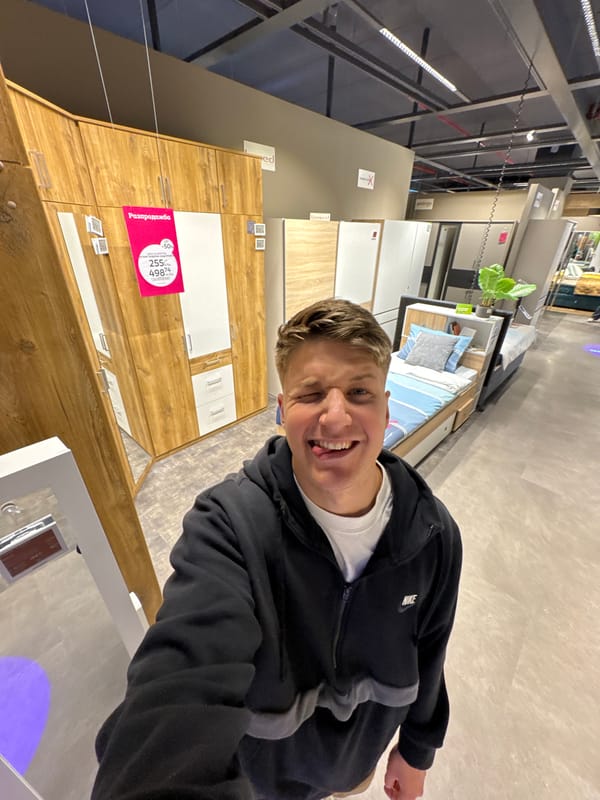 Young man poses playfully in Plovdiv furniture store