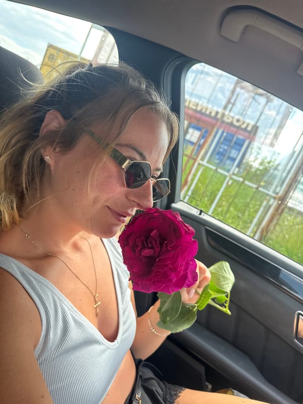 Couple poses with flowers around Mercedes in Bulgaria morning