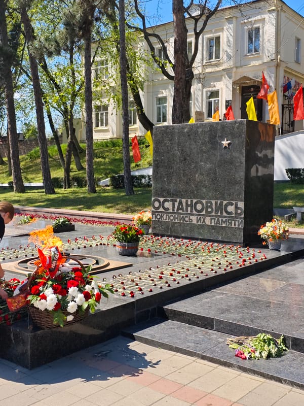 Woman places flowers at war memorial in Pyatigorsk