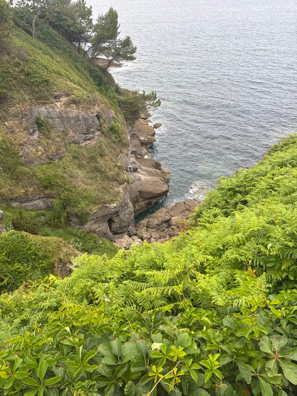 Santander's rocky coastline and Cabo Mayor lighthouse, June afternoon