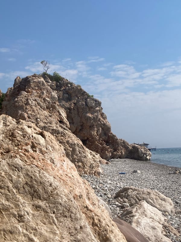 Morning at a rocky Kemer beach, swimming and shoreline details