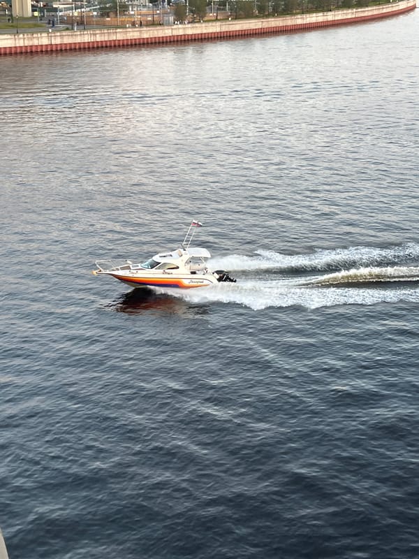 Boats on the water and a motorcycle parked near St. Petersburg