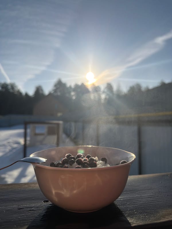 Child enjoys berry porridge outdoors on sunny day in Russia