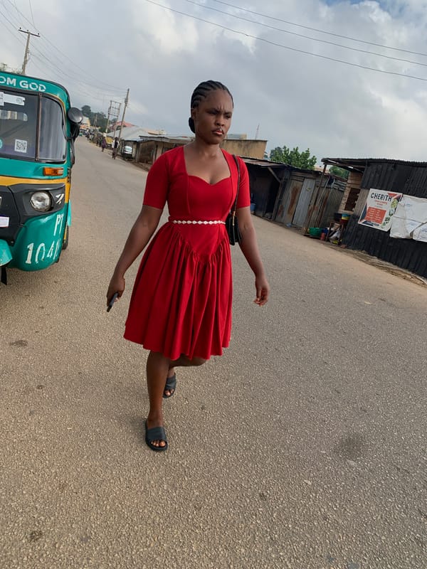 Morning foot traffic on a paved street in Jos, Nigeria