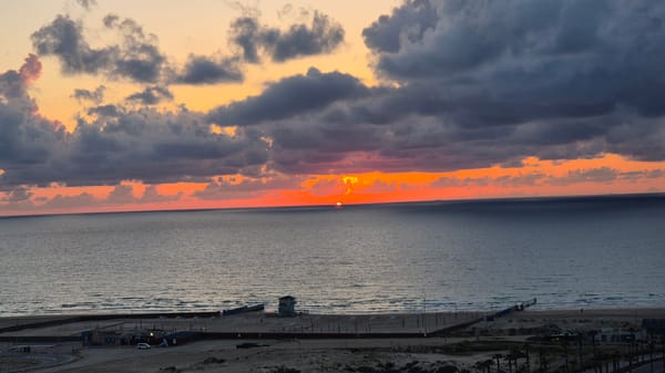 Sunset observed over sea with colorful cloudy sky