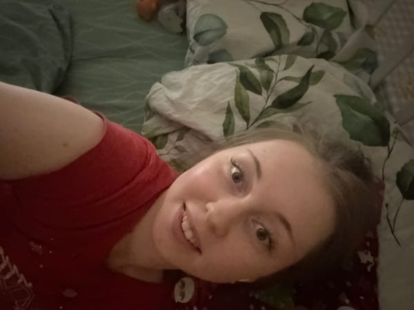 Woman photographed with toys and pillows during indoor session