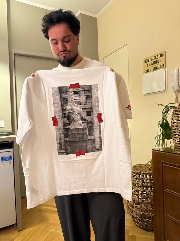Man displays Cattelan L.O.V.E statue t-shirt in Milan
