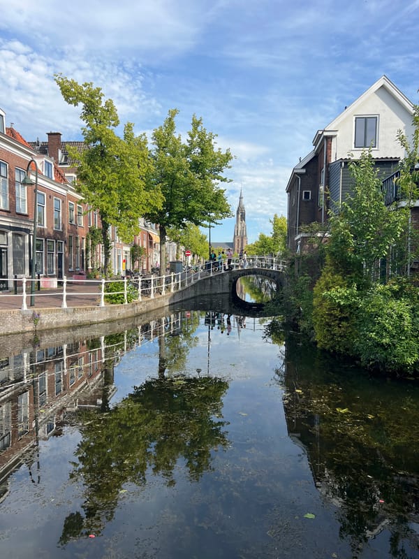 Quiet canal scene along the streets of Delft