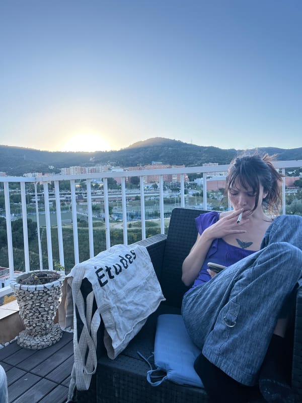 Woman and cat share quiet sunset moment on Barcelona balcony
