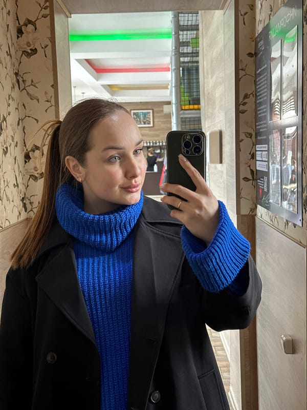 Woman documents indoor visit with selfies and cat in Chaikovsky