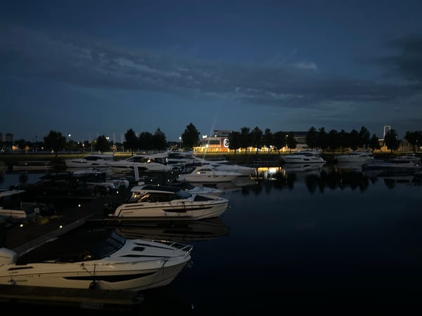 Riga marina at dusk, nightlife starting nearby