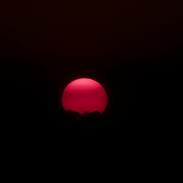 Pink and red sunset settling over the Novi Ligure countryside