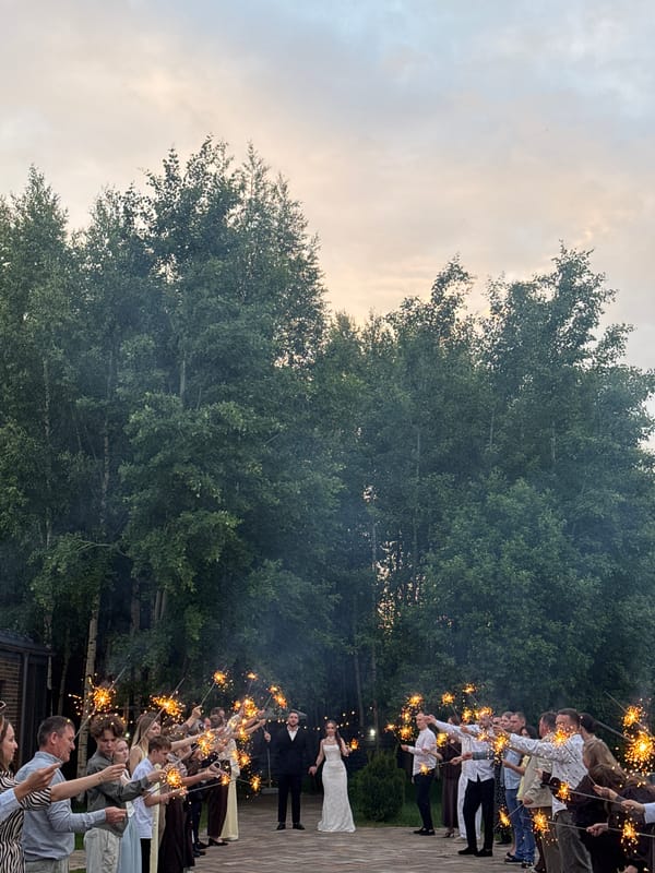 Wedding couple walks hand-in-hand during twilight ceremony in Perm
