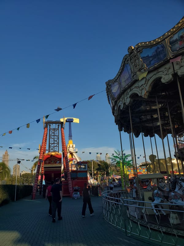 Carnival rides, prize booths, and city streets in Curitiba