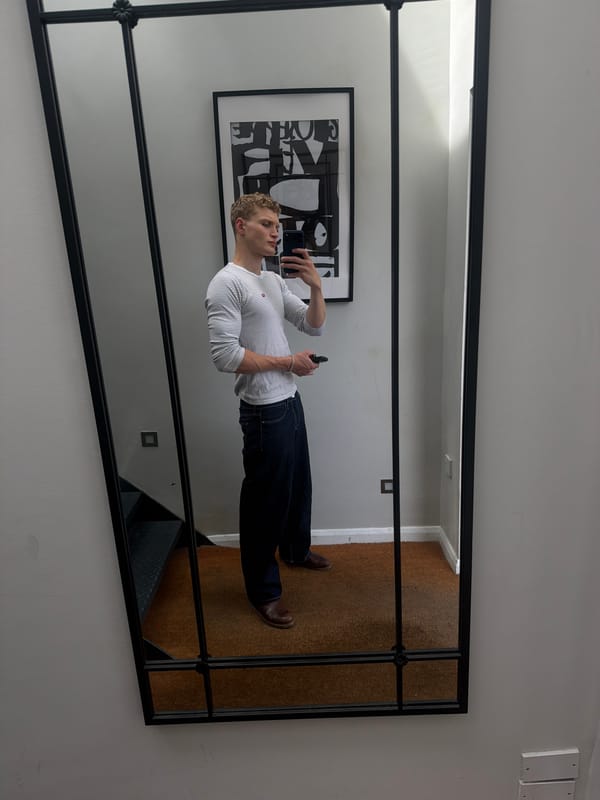 Mirror selfie in a London room, casual daytime fit