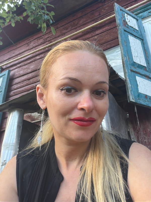 Outdoor selfie in front of a weathered wooden building