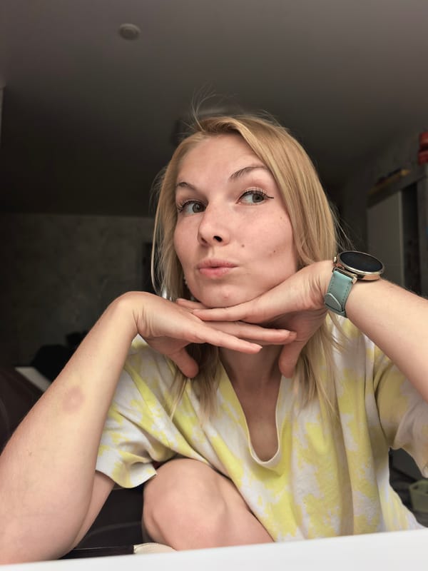 Woman poses in tie-dye shirt, gazing upward