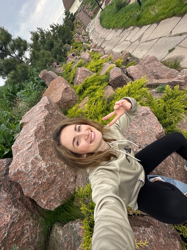 Two women pose for photos at Zakharivka rock formations