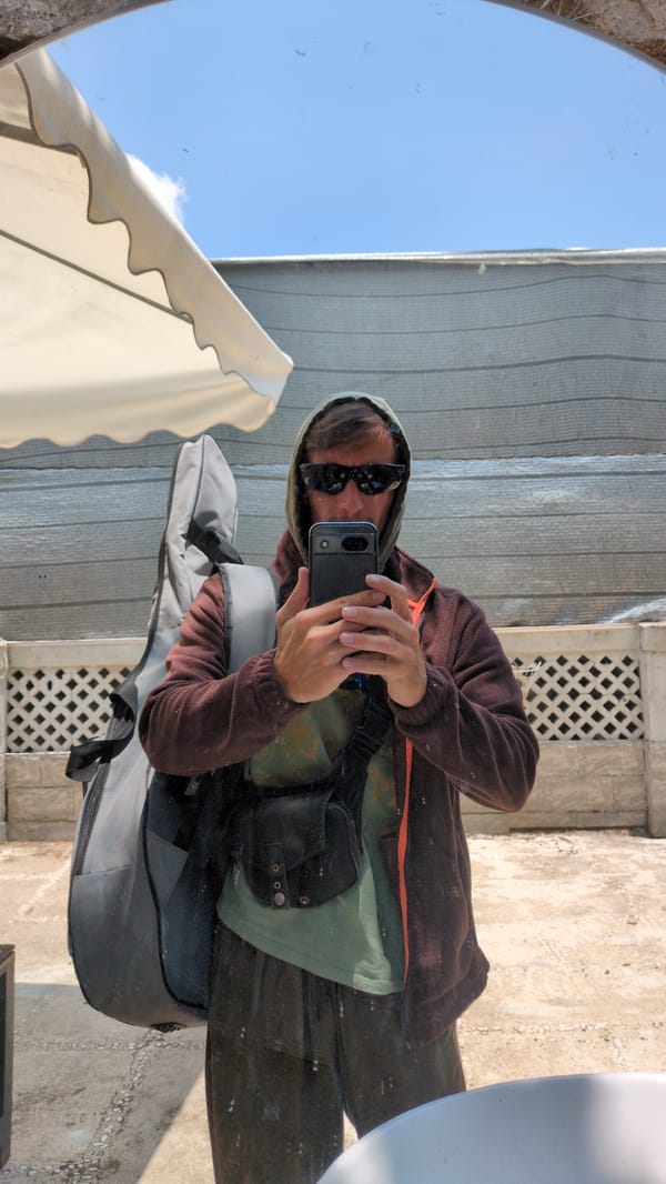 Hooded photographer with guitar case spotted in Da Lat