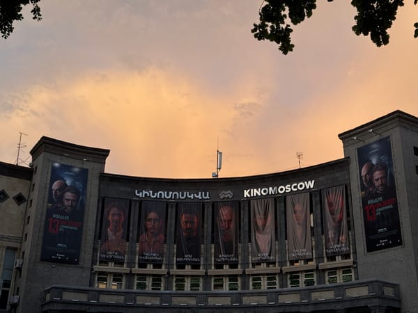 Crowd gathers at Yerevan's Kinomoskva cinema with Armenian banners