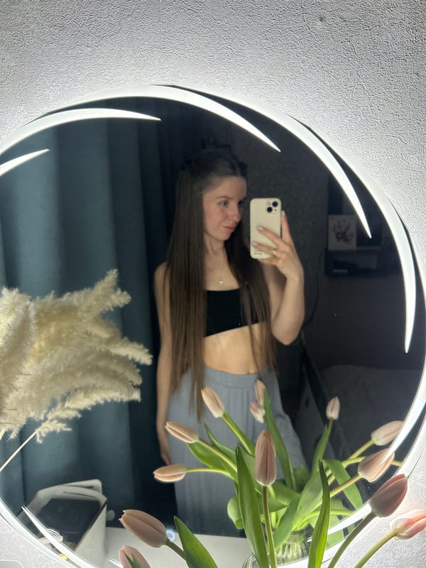 Woman takes tulip selfies in ring light mirror, Klin