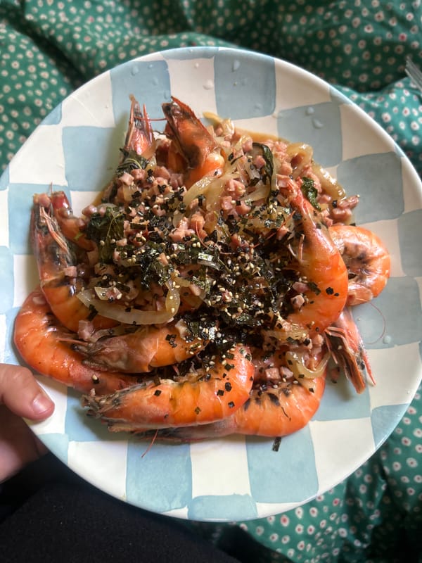 Prepared shrimp dish observed on floral fabric in LA