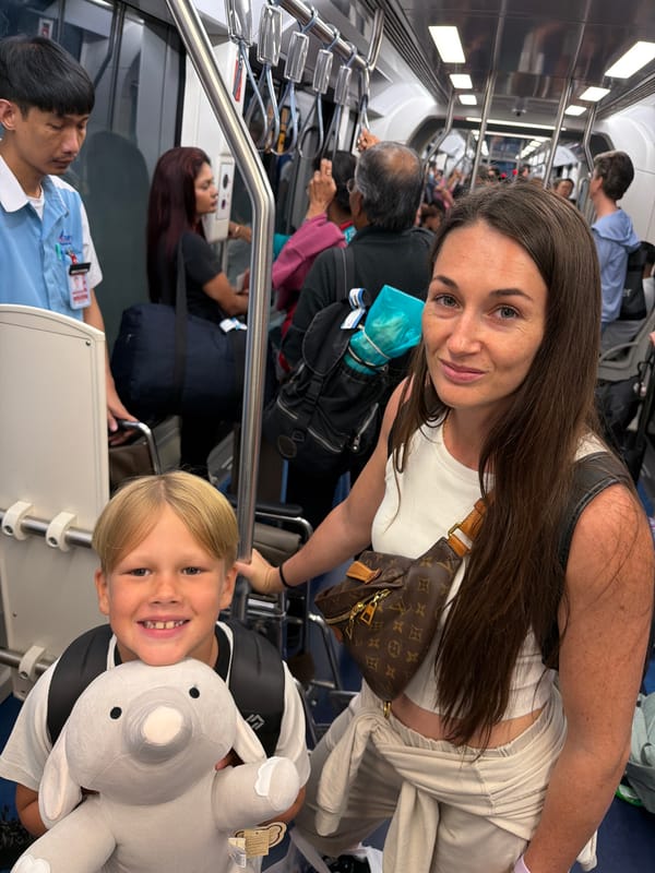 Crowded train ride through Nong Prue with luggage and drinks in hand