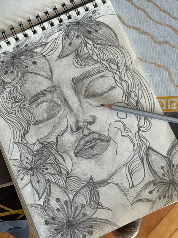 Artist sketches portrait while working on laptop in Yerevan
