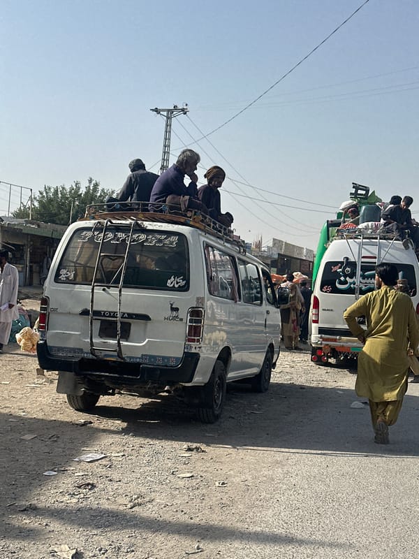 Overloaded vans spotted on Quetta street during sunny day