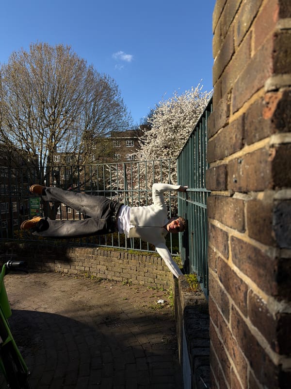 Young men pose for photos on sunny London streets