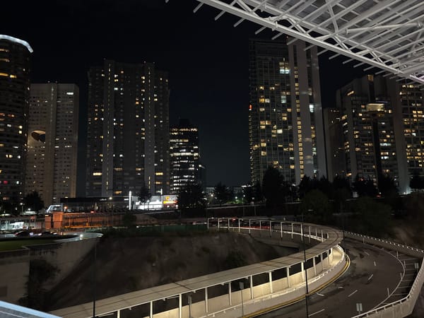 Nighttime cityscape captured in Mexico City with illuminated skyline