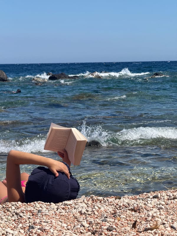 Afternoon reading session on a Sardinian pebble beach