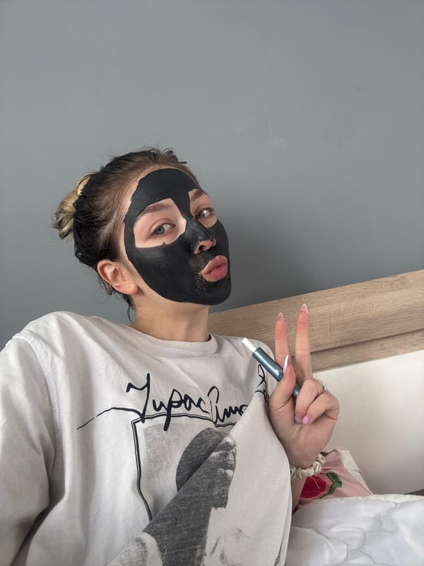 Person applies facial mask treatment indoors in Yambol