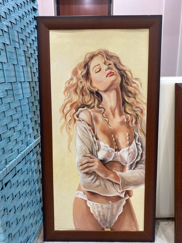 Art collection featuring reclining female figures displayed indoors