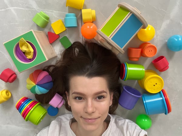 Woman plays with children's toys on floor in Cyprus