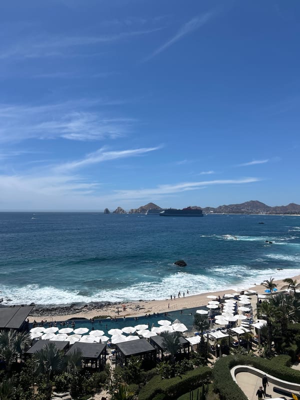 Aerial views capture Cabo San Lucas coastline under clear skies