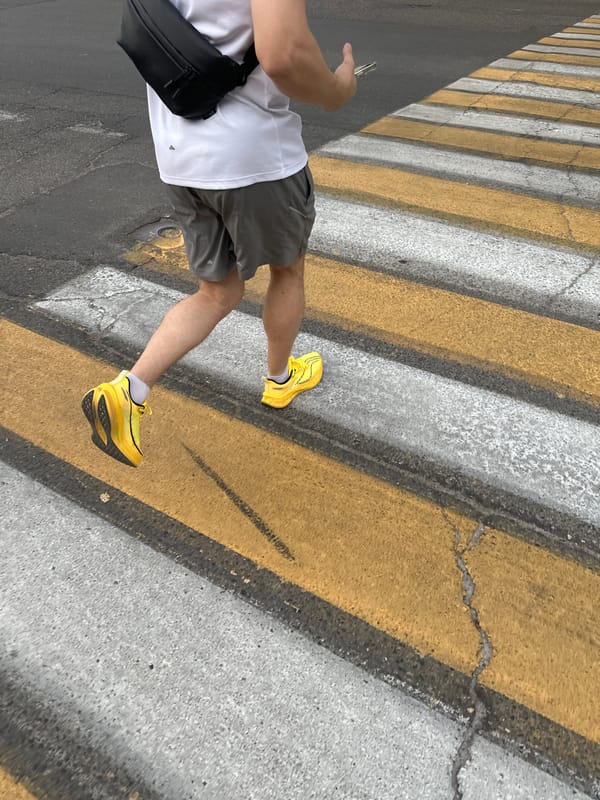 Man in athletic wear stands on crosswalk in Tashkent