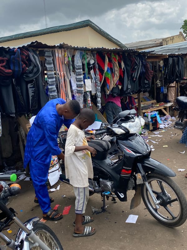 Young men with motorcycle captured in Lokoja street scenes