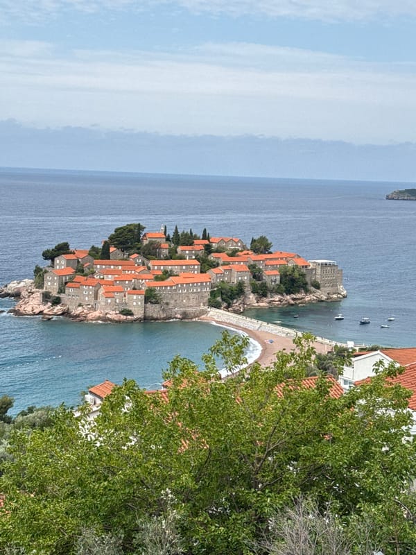 Tourists document scenic views of Montenegro's Sveti Stefan island village