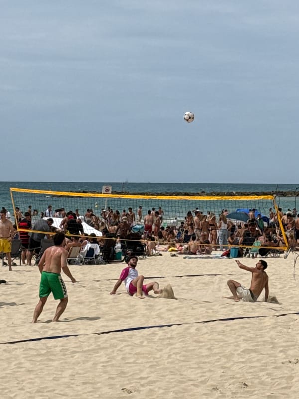 Tel Aviv scenes: beach volleyball game, damaged building observed