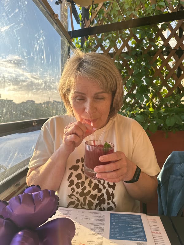 Family enjoys outdoor dining with cocktails and balloons in Perm